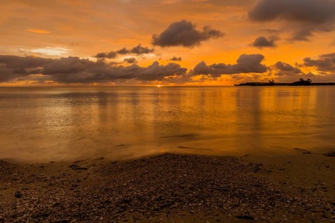 Beautiful sunset over ocean water taken from a beach in Guam