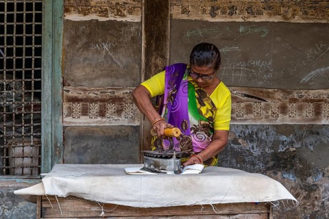 Woman flat iron cloth with a very old Unesco site, Ahmedabad, Gujarat, India, Asia