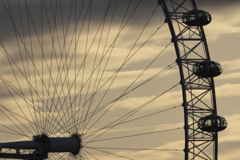London Eye or Millennium Wheel tourist observation wheel close up of pods and spokes at sunset,