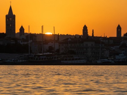 Sunset, silhouette of the church towers of Rab, town of Rab, island of Rab, Kvarner Gulf Bay,