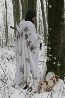 Hunter in winter with snow shirt and hunting dog Jack Russell Terrier, Allgaeu, Bavaria, Germany,