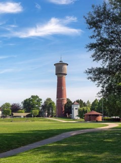 Brick water tower stands on a green lawn under a clear blue sky, Ladenburg, Baden-Wuerttemberg,