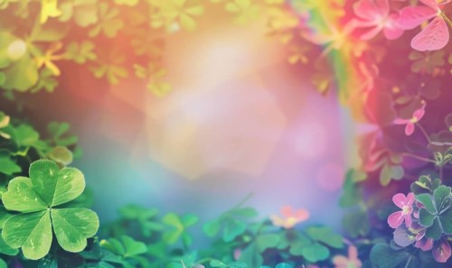 Glowing sunlight filters through vibrant green clovers with soft pink details, creating an ethereal