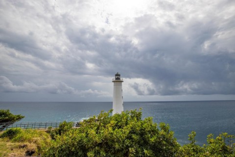 White lighthouse on a steep coast. Dramatic clouds with a view of the sea, pure Caribbean at Le
