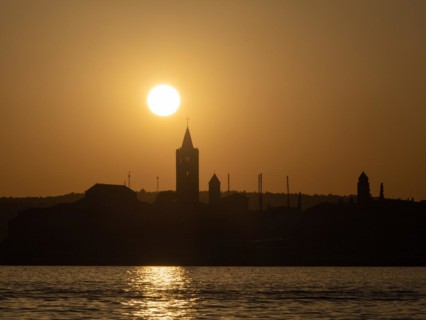 Sunset, silhouette of the church towers of Rab, town of Rab, island of Rab, Kvarner Gulf Bay,