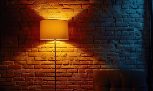 A standing lamp with a classic design illuminates a room with blue and orange lighting,