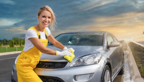 AI generated, A blonde woman washes a car by hand, silver sports car