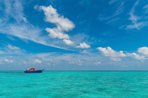 Little boat in the turquoise waters of Agatti Island, Lakshadweep archipelago, Union territory of