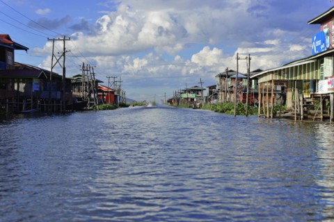 Village on stilts along a quiet waterway, Inle Lake, Myanmar, Asia