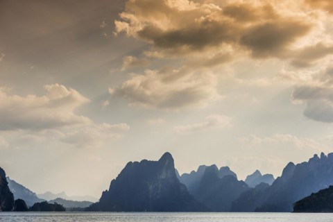 Limestone rocks in the evening light in Cheow Lan Lake in Khao Sok National Park, evening, sunset,