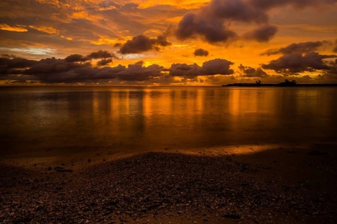Beautiful sunset over ocean water taken from a beach in Guam