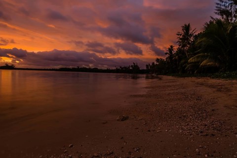 Beautiful sunset over ocean water taken from a beach in Guam