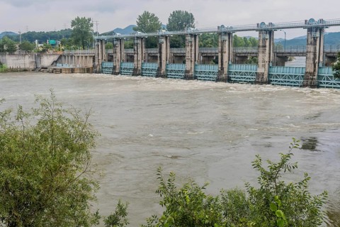 Hydroelectric dam managing rising floodwaters in a swollen river, in South Korea