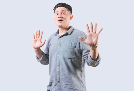 Scared man with raised hands isolated. Young man with scared face with raised hands. Scared and