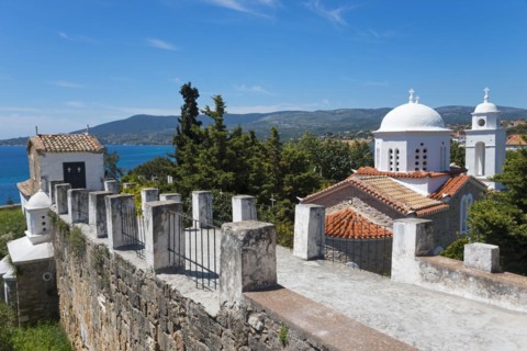 View of churches and the sea, surrounded by a stone wall and red roofs, Byzantine fortress with
