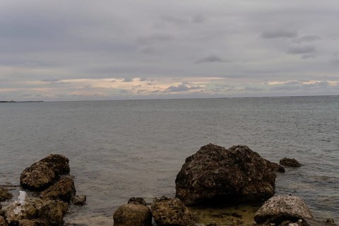 Seascape of the pacific ocean with a rocky shoreline taken on a cloudy day in Guam