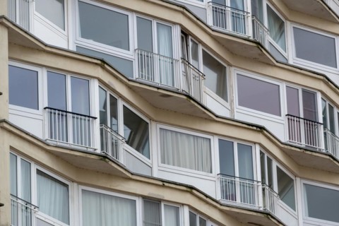 Curved residential building with curved balconies and reflective windows, Blankenberge, Flanders,
