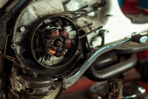 Close-up of a classic italian vintage scooter motorcycle engine's stator assembly in a workshop