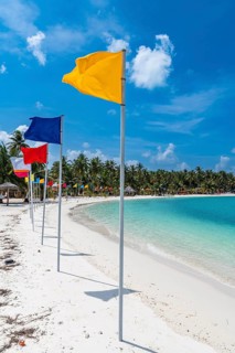 White sand beach with many flags, Bangaram island, Lakshadweep archipelago, Union territory of