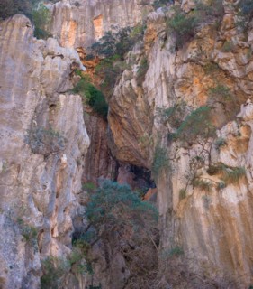 Torrent de Pareis, large rock opening surrounded by striking rock structures, orange-red cliffs