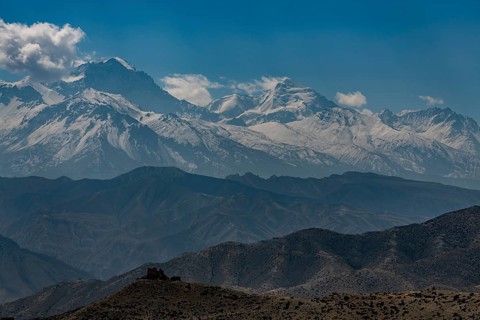 Old fortress in the desert landscape before the Annapurna mountain range, Kingdom of Mustang,