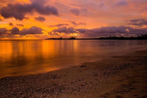 Beautiful sunset over ocean water taken from a beach in Guam