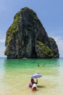 Man and child with parasol in the sun in the sea, ocean, sunshade, Andaman Sea, ozone, heat,