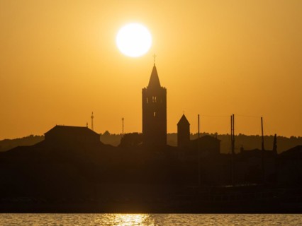 Golden evening light at sunset, silhouette of the church towers of Rab, town of Rab, island of Rab,
