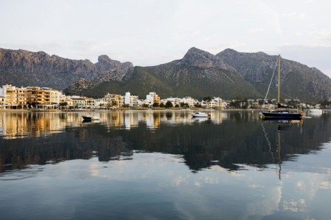 Village by the sea and mountains at sunrise, Port de Pollenca, Serra de Tramuntana, Majorca,