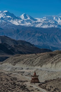 Stupa in a desert landscape before the Annapurna mountain range, Kingdom of Mustang, Nepal, Asia