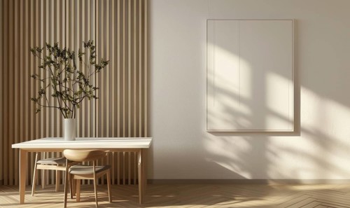 Elegant dining space with a modern wooden table, flowers in vase, and a minimalist empty frame on