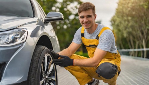 AI generated, A mechanic changes the tyres on a customer's car, tyre fitting, silver car