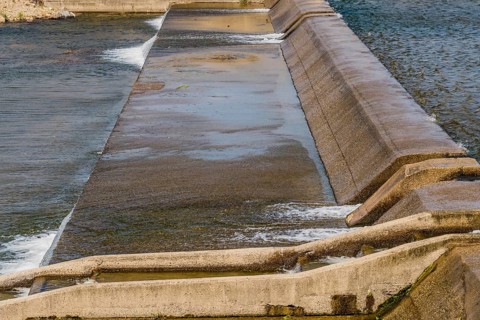 Step-like concrete dam with water cascading down its channels, in South Korea