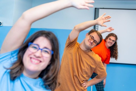 Selective focus on a man with down syndrome and friends enjoying gym class