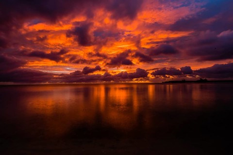 Beautiful sunset over ocean water taken from a beach in Guam
