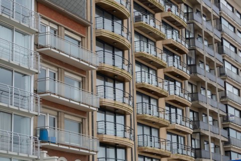 Close-up of a multi-storey building with balconies and brick facade, Blankenberge, Flanders,