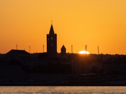 Golden evening light at sunset, silhouette of the church towers of Rab, town of Rab, island of Rab,