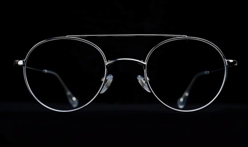 Contrasting silhouette of aviator sunglasses with a white outline on dark background AI generated