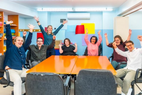 Portrait of happy joyful people with special needs in a class with teacher