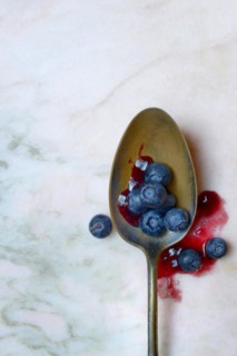 Blueberries and blueberry jam in spoons, blueberry