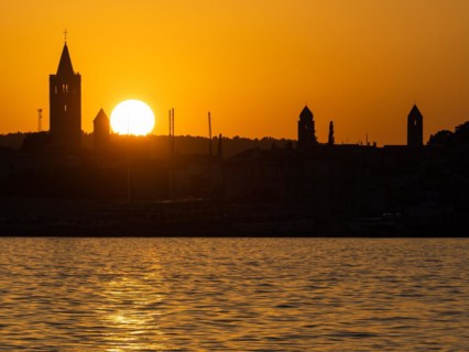 Sunset, silhouette of the church towers of Rab, town of Rab, island of Rab, Kvarner Gulf Bay,