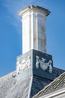 White chimney with ornate decorations on a slate roof, Middelburg, Zeeland, Netherlands