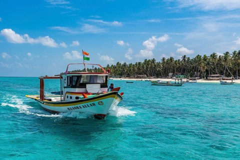 Little boats before a palm fringed white sand beach, Agatti Island, Lakshadweep archipelago, Union