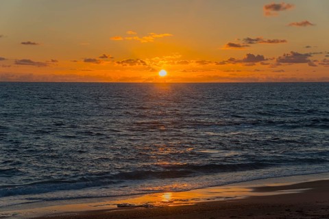 Dramatic sunset over the sea with radiant light and reflections on the water, Finikounda,