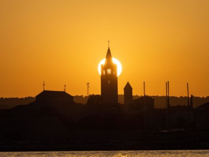Golden evening light at sunset, silhouette of the church towers of Rab, town of Rab, island of Rab,