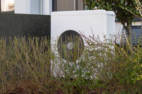 Heat pump in the front garden of a terraced house in Duesseldorf, North Rhine-Westphalia, Germany,