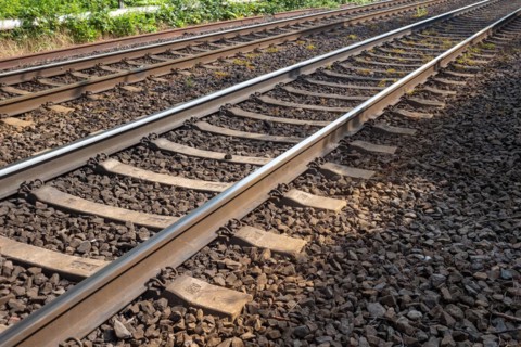 Railway tracks with wooden sleepers and ballast bed stretching into the distance, Oberhausen, North