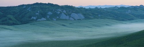 Early morning fog shortly in front of sunrise in the Crete Senesi, Province of Siena, Tuscany,