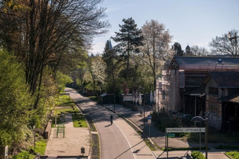 Urban leisure path in spring with a person walking in the shade, cycle path, Nordbahntrasse,