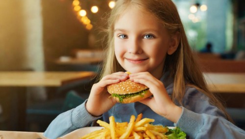 AI generated, A young girl, 10 years old, enjoys her burger, hamburger, fast food, restaurant
